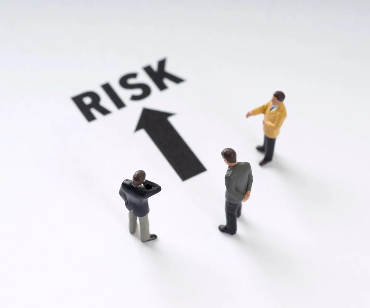 Team planning risk mitigation steps around a meeting table