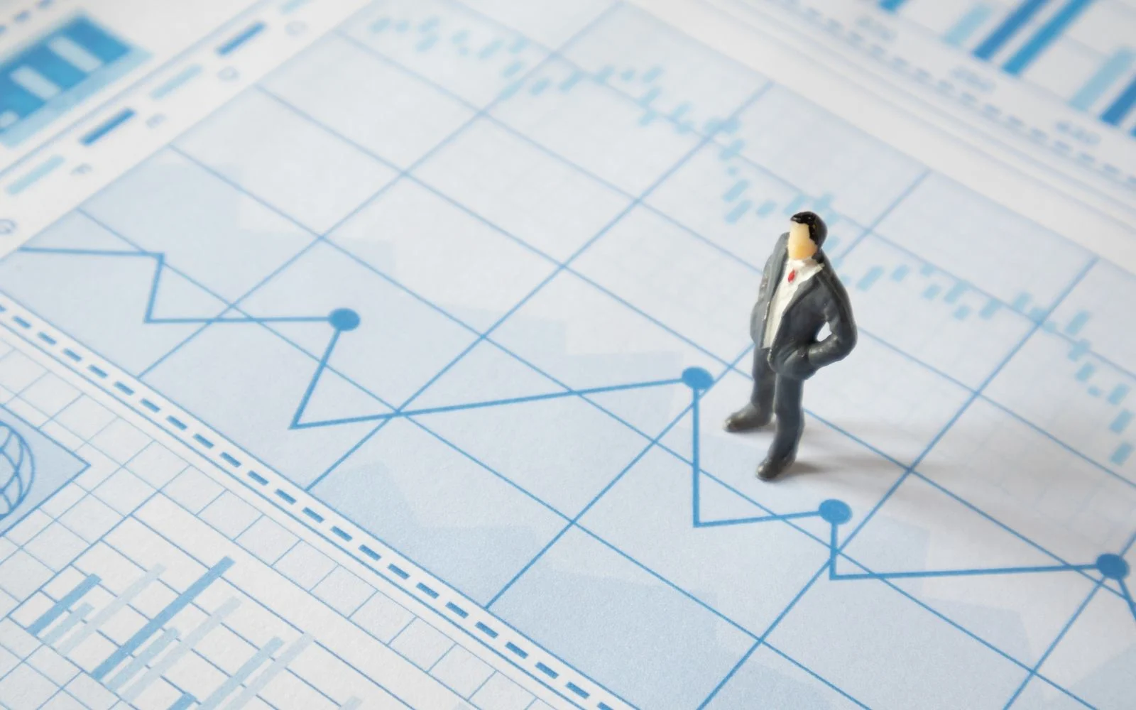 Consultant reviewing business risk charts and reports on a desk