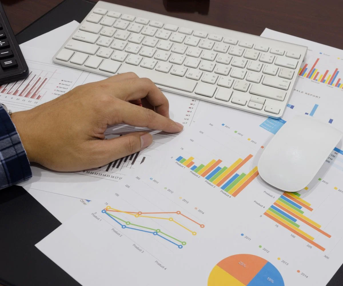 Consultant reviewing business strategy notes and charts at a desk