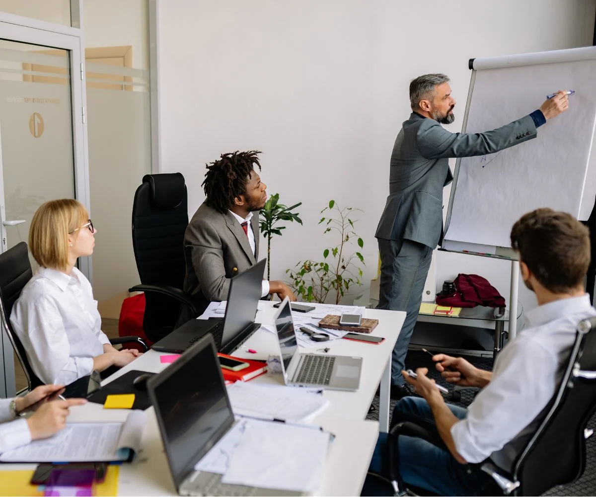 Employees being trained on a newly documented business process